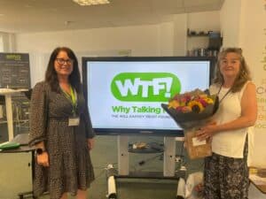 Julie presenting Joanna with flowers to say thank you for leading sessions on mental health and suicide prevention.