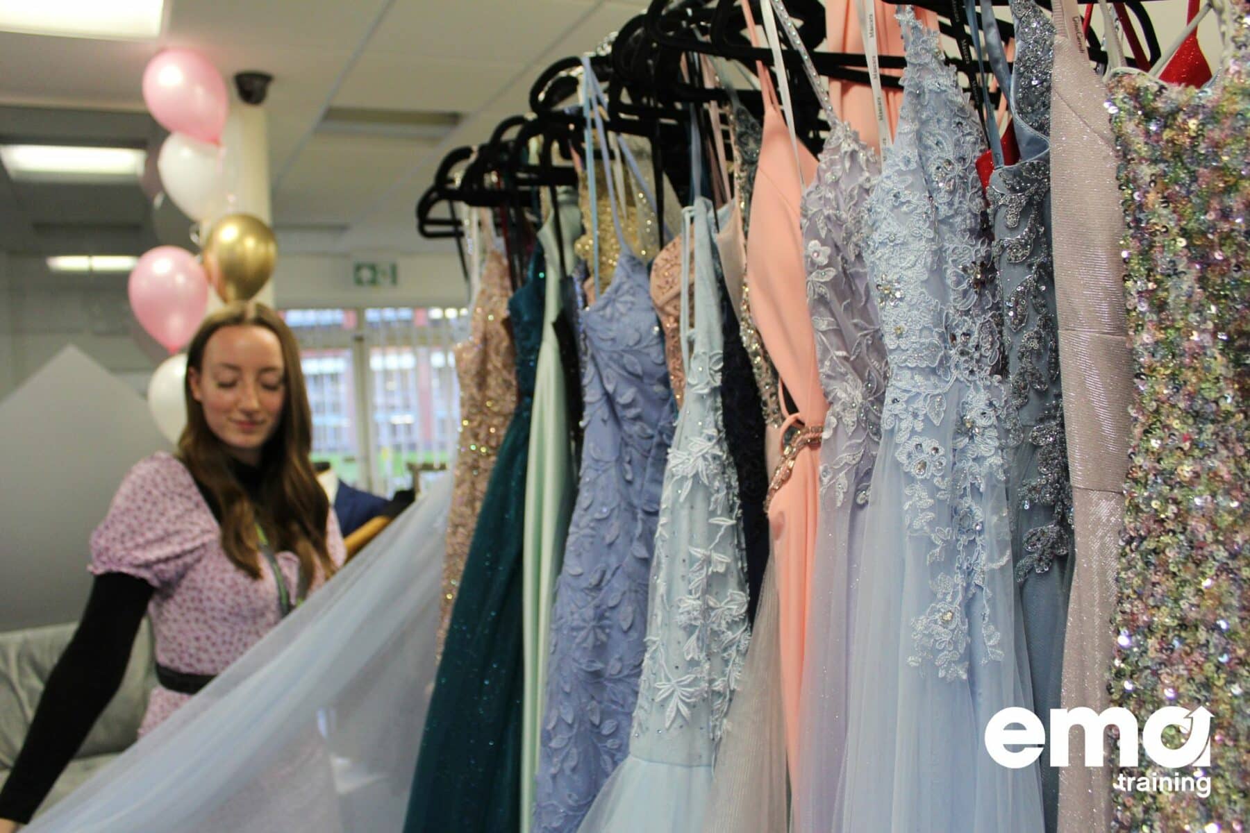 Girl looking through a range of stunning prom dresses at EMA's Derby Prom Fair.