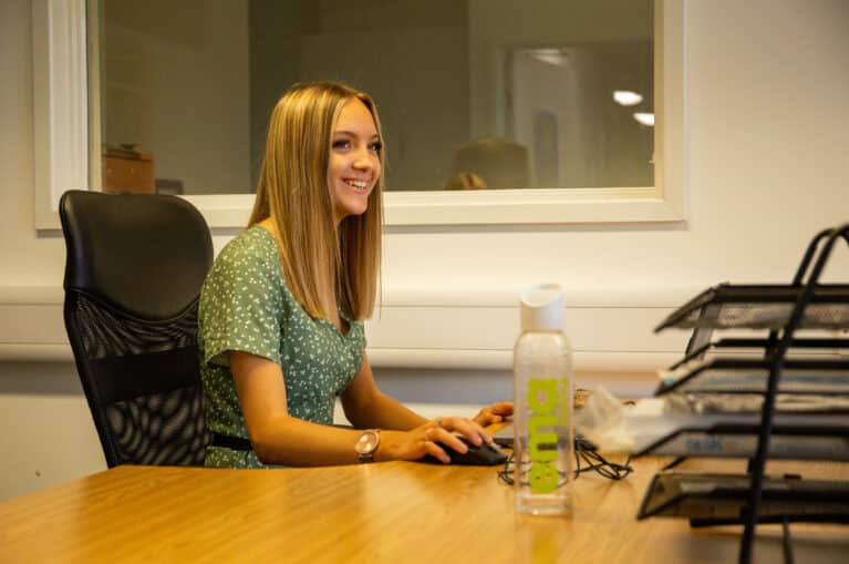 EMA's Finance Apprentice, Lupita, sat at her desk.