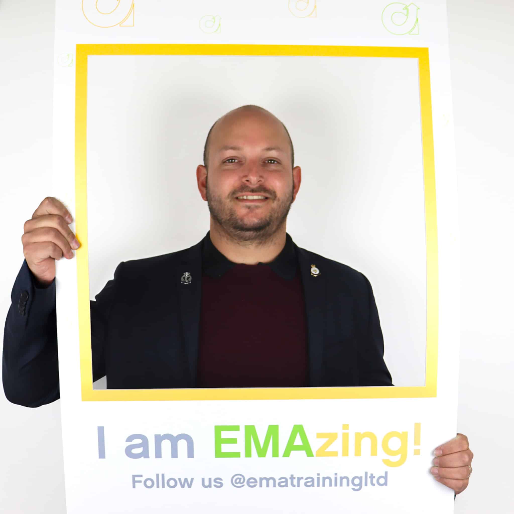 EMA's Accountancy Trainer, Mike, holding frame and smiling.