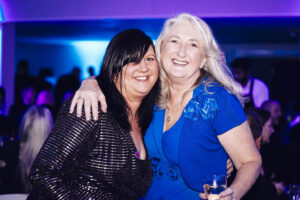 EMA's CEO Tracy Mosely and Jo Sanders smiling at the Derby Business Awards after winning the Small Business of the Year award.