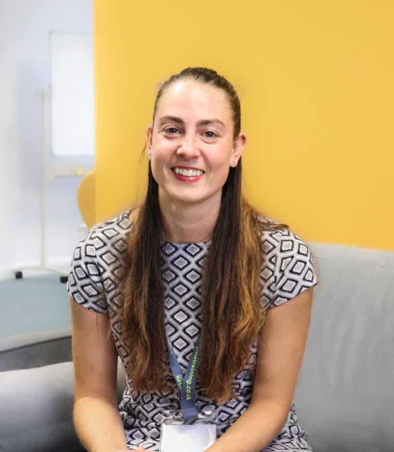 EMA's Digital Mentor, Holly, sitting down and smiling.