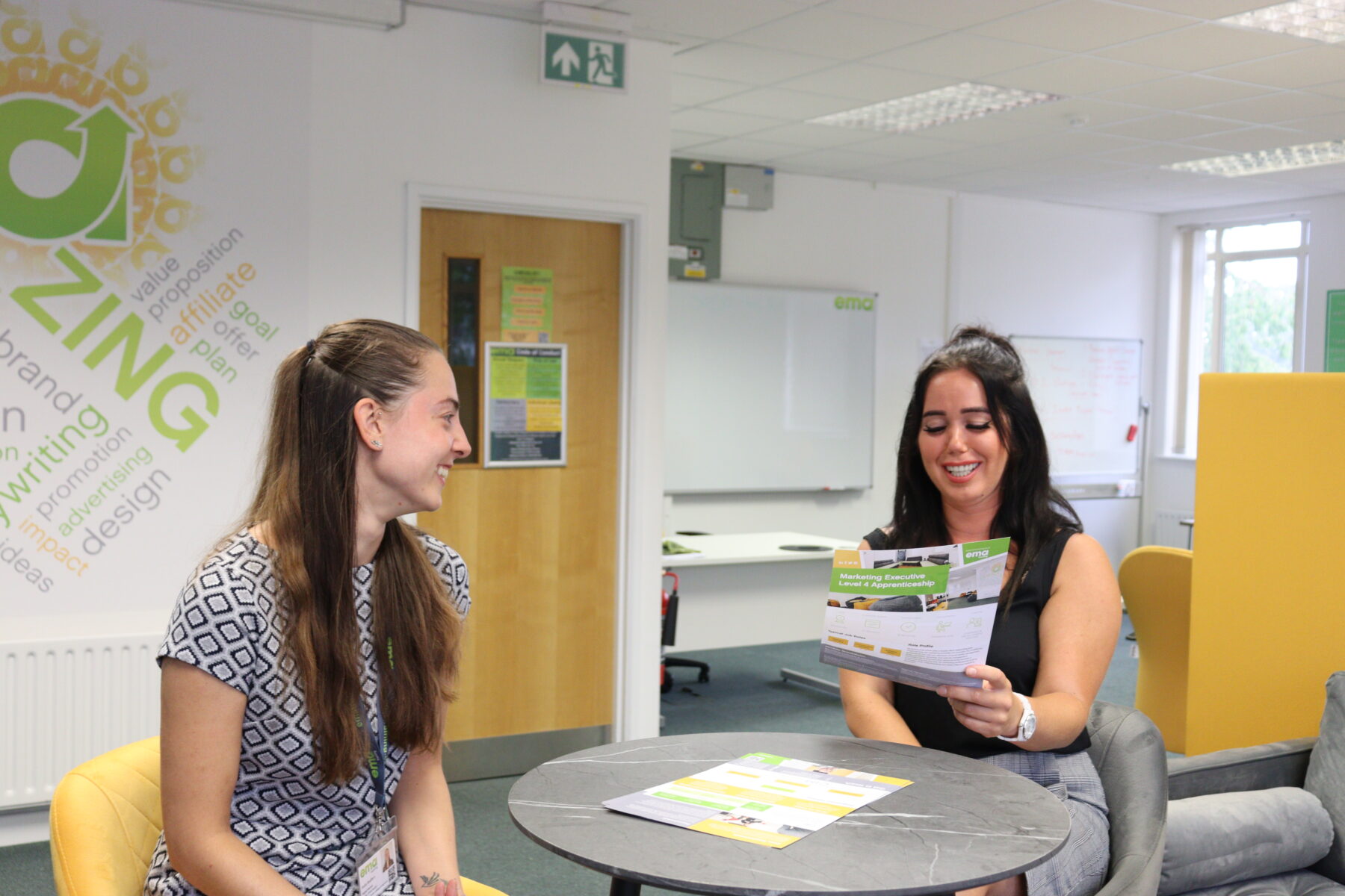 Holly, Digital Trainer and Louisa, Digital Programme Lead, looking over the digital course brochures.