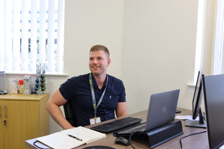 EMA's Finance Director, Matt, sat at his desk. Matt helped put together EMA's 