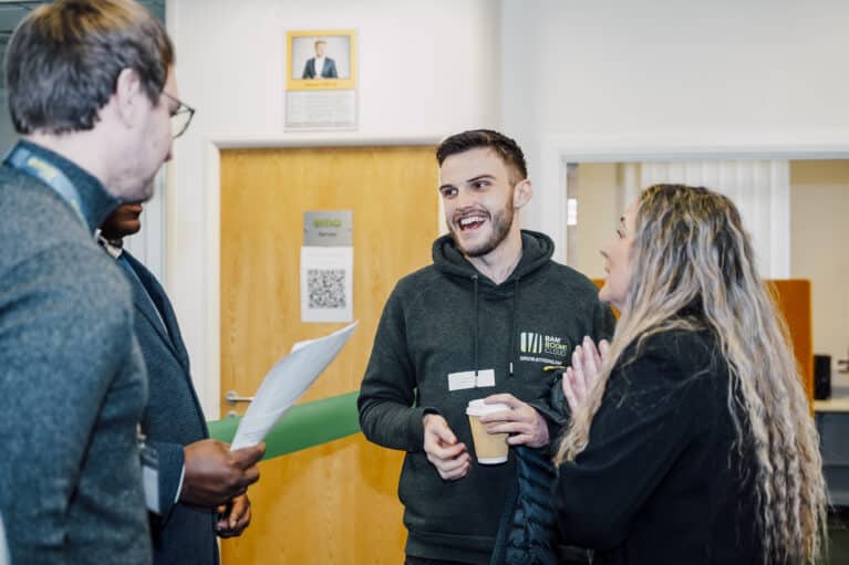 Three people chatting at an EMA event.