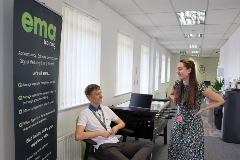 Two members of EMA staff chatting on the top floor of trhe Digital Training Hub. This picture was taken during the 2022 IT & Digital Careers Fair.