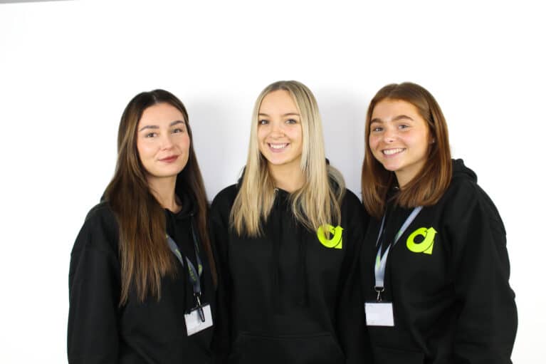 EMA Training's Fabulous Finance Team Wearing their EMA Hoodies. From left to right, there is Hollie, Lupita, and Rosie.