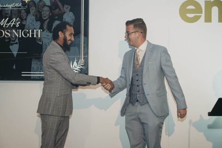EMA Awards: AAT Trainer, Adill shaking the hand of the winner of the Apprenticeship Ambassador award.