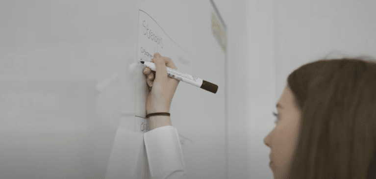 Marketing Apprentice Writing on white board