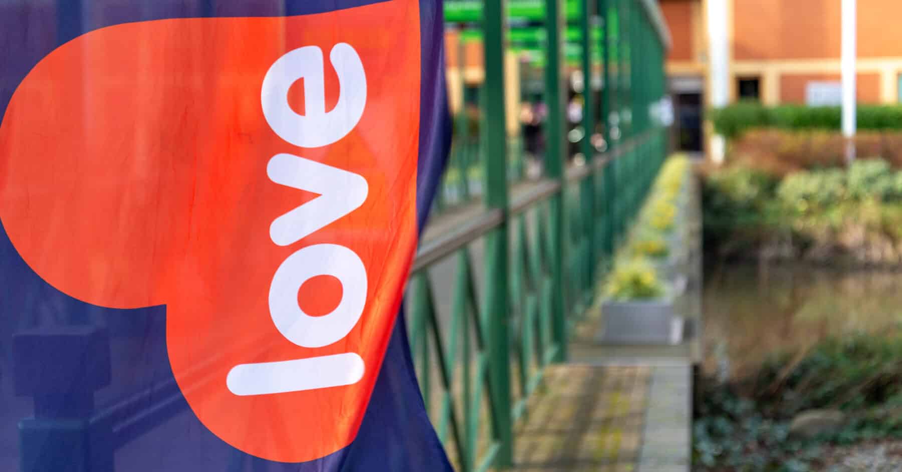 Love Business flag with blurry walkway background
