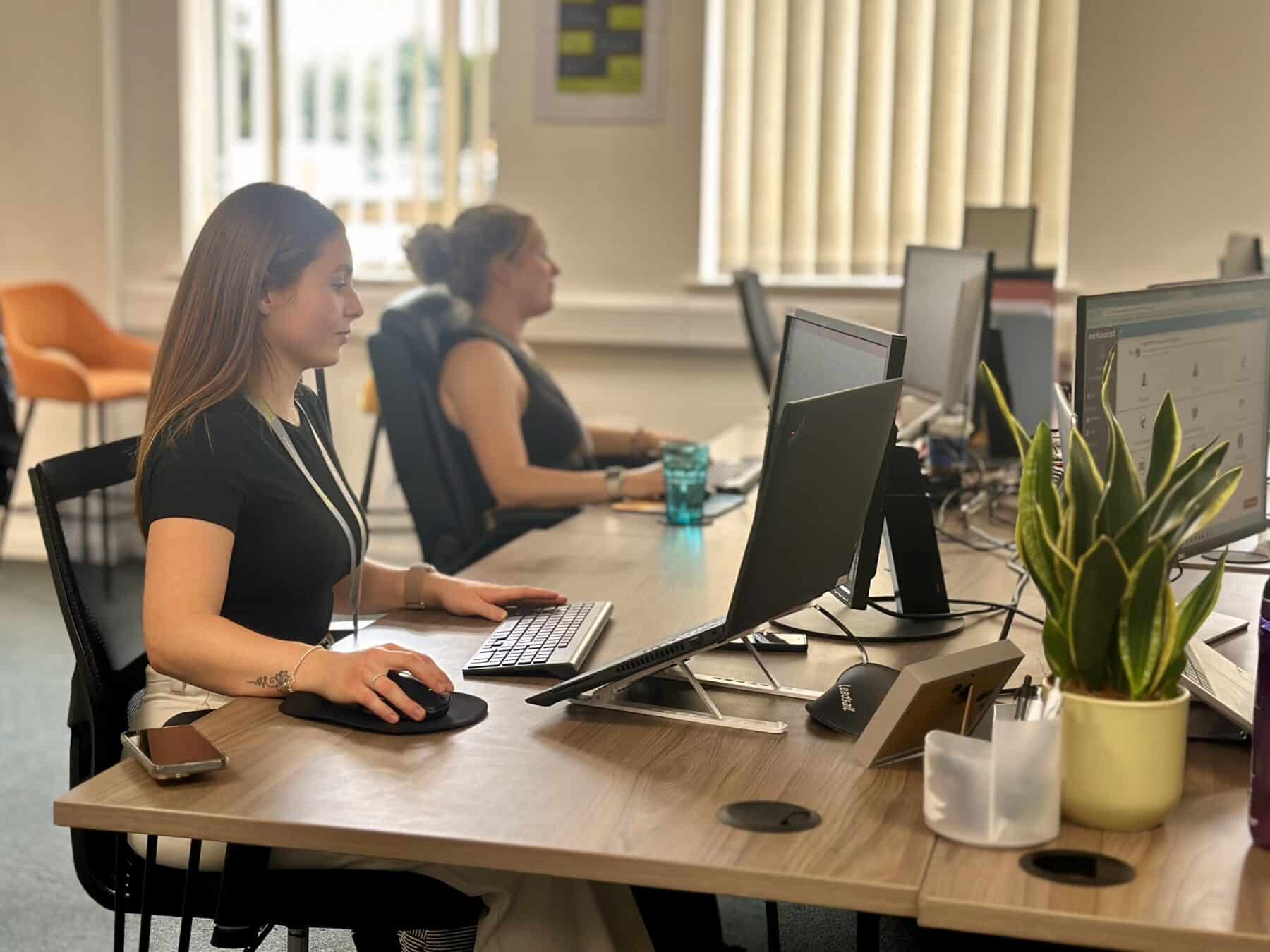 Business Administration staff members working opposite each other.