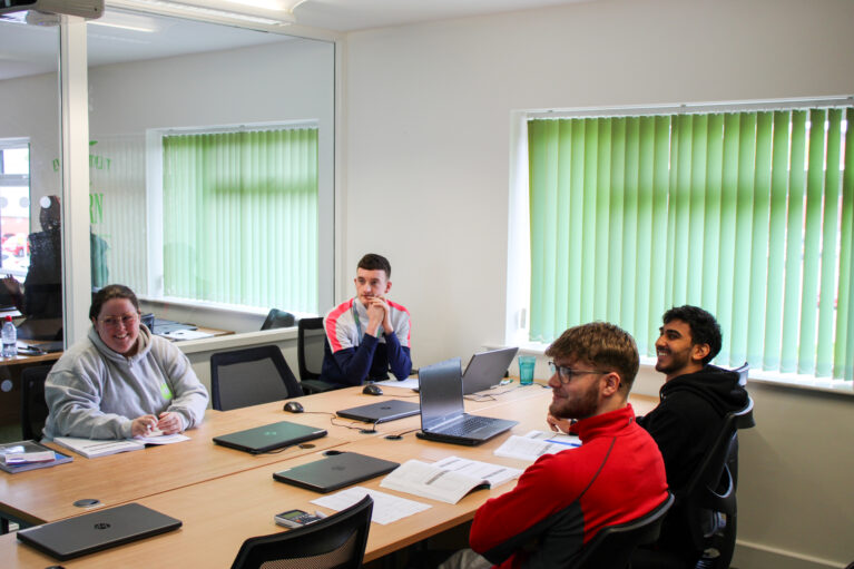 4 learners in a classroom studying their AAT qualification