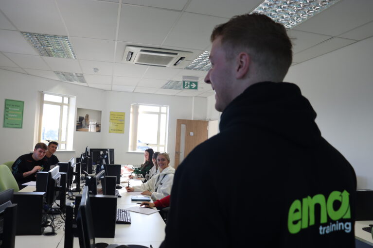 Side profile of a teacher, showing learners smiling in the background
